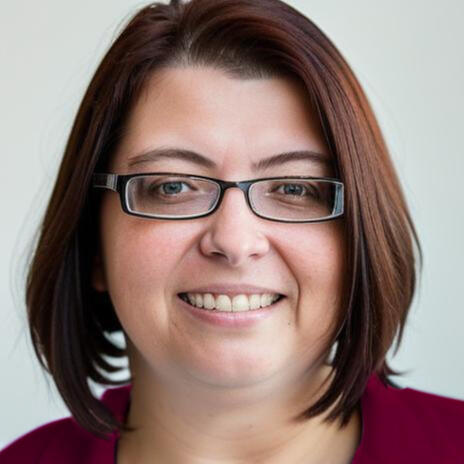 Headshot of Christiane Link, a white woman with brown hair and glasses, she smiles